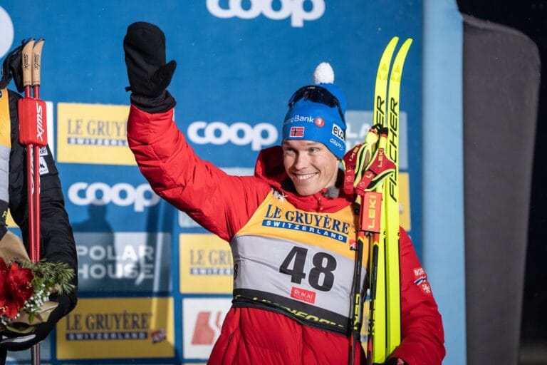 Martin Løwstrøm Nyenget of Norway celebrates on the podium after competing in the men's 10km classic interval start during the FIS Cross-Country World Cup
